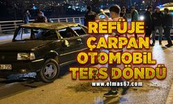 Refüje çarpan otomobil ters döndü