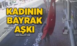 Bastonla yürüyen kadın iş yeri önündeki bayrağı öptü