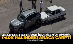 Araç taşıyıcı tırdan indirilen otomobil park halindeki araca çarptı
