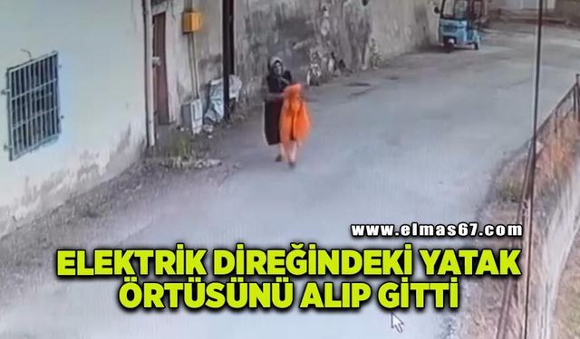 Elektrik direğindeki yatak örtüsünü alıp gitti